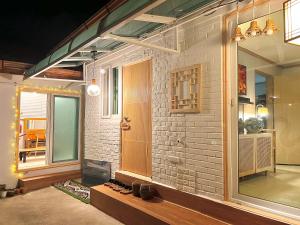 a room with a brick wall and a window at Private Korean Entire Villa with Garden up to 10 in Seoul