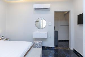 a bedroom with a white bed and a mirror at Cairo Homes Nile View Studios Manial in Cairo +81 photos