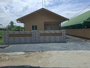 a building with a fence in front of it at Zara Appartement in Paramaribo