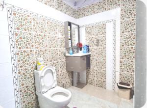 a bathroom with a toilet and a sink at Dream Big Accommodation in Apia +64 photos