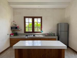 a kitchen with a refrigerator and a window at Agusta Lake View Bedugul in Pabean Buleleng +11 photos