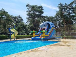 a water slide in a swimming pool at Mobile home Keiheuvel 6p in Balen