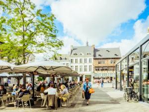a group of people walking down a street in a city at City apartment with terrace in Hasselt