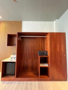 a wooden cabinet with acomputer in a room at PAN HOTEL AND RESORT in Abucay