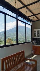 a room with a bench in front of a large window at Fatmara Villa Full House in Kejajar