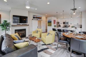 a living room with a couch and a table at Downtown WP Loft 14 I Huge Hot Tub I Great Views I Additional Bunk Area I Activity Program in Winter Park