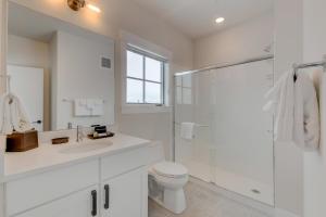a white bathroom with a toilet and a shower at Downtown WP Loft 14 I Huge Hot Tub I Great Views I Additional Bunk Area I Activity Program in Winter Park +11 photos