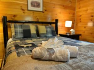 a bedroom with a bed with towels on it at Pluggy's Place - Perfect Location - Outdoor Fire pit in Beattyville