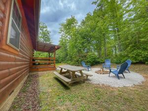 a picnic table and chairs outside of a cabin at Pluggy's Place - Perfect Location - Outdoor Fire pit in Beattyville