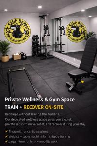 a gym with a black chair and a gym space at The Black Sheep Backpackers in Queenstown