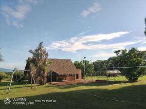 a house with a playground in front of it at Vai Iti Lodge in Afaahiti