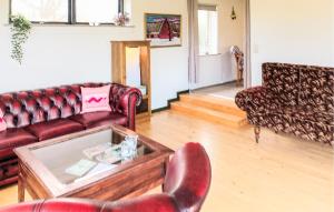 a living room with a couch and a table at 1 Bedroom Nice Home In Hurup Thy in Ullerup