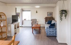 a living room with a couch and a table at 1 Bedroom Nice Home In Hurup Thy in Ullerup