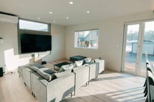 a living room with couches and a flat screen tv at Grandeur Biei in Biei