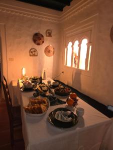 a table with many plates of food on it at L'autre Dar Rita in Houmt Souk +21 photos