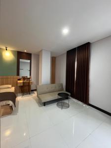 a living room with a couch and a table at Pangeran Residence 2 in Adi Sutjipto