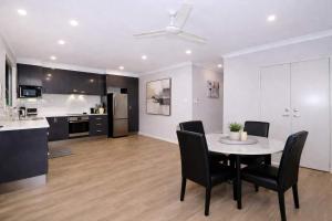 a kitchen and dining room with a table and chairs at Golfside Haven 2 Bedroom Duplex with Golf Course in Rosslea