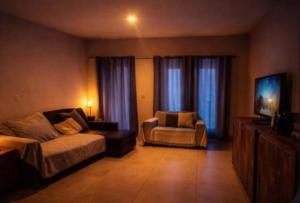 a living room with a couch and a chair at Casa charmosa familiar in Chapada dos Guimarães