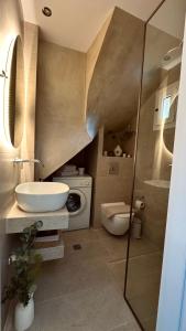 a bathroom with a sink and a toilet at 7th Heaven Luxury Villa in Kallithea Halkidikis