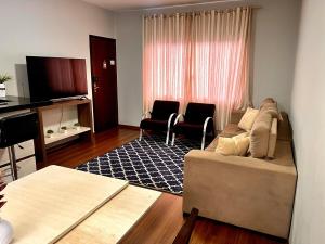 a living room with a couch and two chairs at Super comfortable house 3 bedrooms in Paranavaí