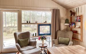 a living room with two chairs and a table and a window at Beautiful Home In Nexø With Sauna in Vester Sømarken