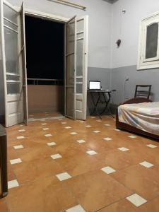 a room with a bed and a wooden floor at Beit Gedi in Cairo +8 photos