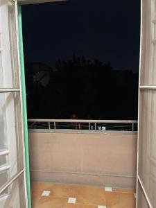 an open door to a balcony at night at Beit Gedi in Cairo