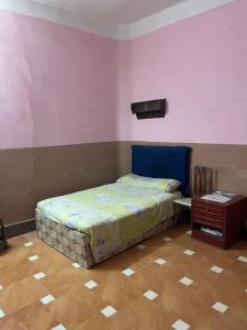a bedroom with a bed and a night stand at Beit Gedi in Cairo
