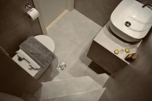 an overhead view of a bathroom with a toilet and sink at 7th Heaven Luxury Villa in Kallithea Halkidikis +46 photos