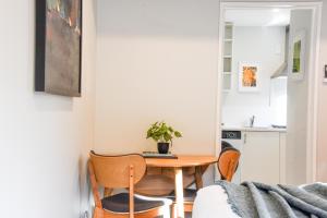 a small kitchen with a table and chairs at Stylish Lyttelton Studio Free Parking in  Lyttelton +11 photos