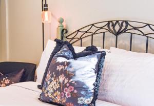 a bed with two pillows on top of it at Stylish Lyttelton Studio Free Parking in  Lyttelton