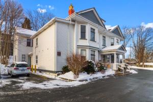 a house with a car parked in a parking lot at Downtown Gem 2BR Tub Parking in St. John's