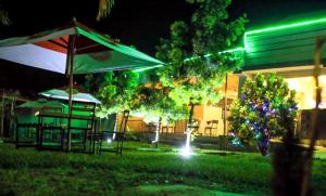 a park with an umbrella and a gazebo at night at Riviera Kivu View in Gisenyi