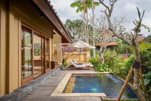 a pool in the backyard of a villa at Komaneka at Monkey Forest Ubud in Ubud