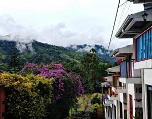 a view of the mountains from between buildings at Casita entera en Salento para 10 personas cerca a la plaza in Salento