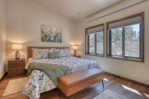 a bedroom with a bed and two windows at The Gold Hill Chalet in Keystone