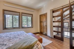 a bedroom with a bed and two windows at The Gold Hill Chalet in Keystone