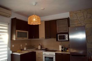 a kitchen with a stainless steel refrigerator and a light at 7th Heaven Luxury Villa in Kallithea Halkidikis