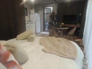 a bed with a blanket on it in a room at Huruhuru Hideaway! Private Cabin in Otatara