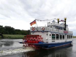 a ferry boat in the water on a river at Ostseedeich 08 in Prerow