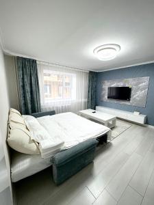 a bedroom with a large bed and a tv at Gegee's House in Ulaanbaatar