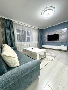 a living room with a couch and a tv at Gegee's House in Ulaanbaatar