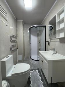 a bathroom with a shower and a toilet and a sink at Gegee's House in Ulaanbaatar
