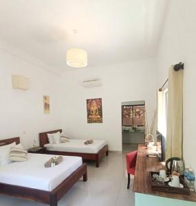 a room with two beds and a couch and a table at La Fontaine de Tara Boutique Hotel in Siem Reap +40 photos
