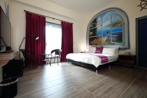 a bedroom with a bed and a large window at Mr Lee Elevator B&B Hualien- Near Dongdamen Night Market in Ji'an