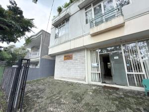 a building with a gate in front of it at Guesthouse Anggrek BSD Syariah in Jombang-kulon +22 photos