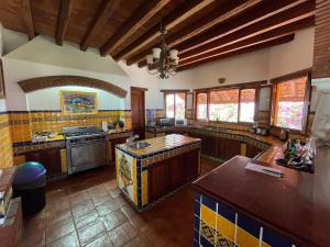 a large kitchen with wooden counters and a stove at Casa Bella in Puerto Escondido
