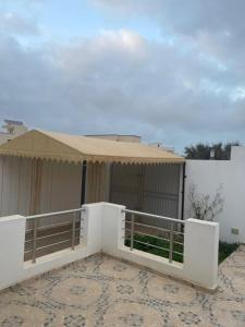 a building with a tent in front of it at Chez montasser in Al Maqārisah