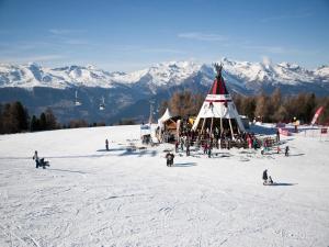 a group of people on a ski slope with a tent at Sunny chalet in Veysonnaz for 10 guests in Veysonnaz