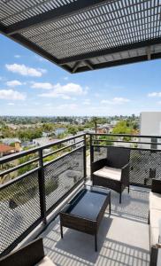 a balcony with a couch and a coffee table at Luxury 2 Bedroom 2 Bathroom With Fitness Center and Pool in Los Angeles